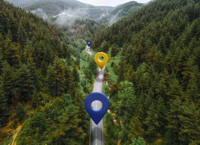 Location symbols on road with mountains