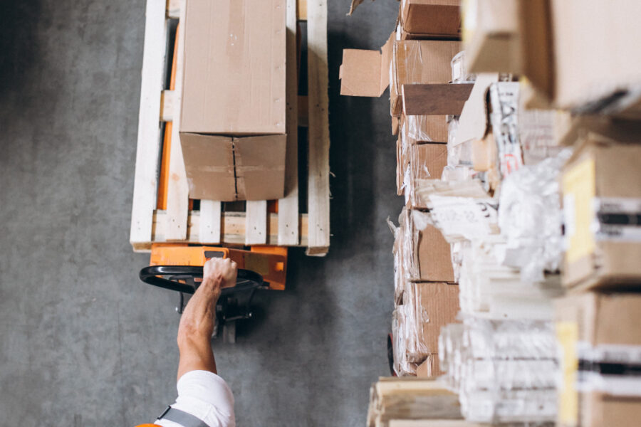 Young man working at a warehouse with boxes