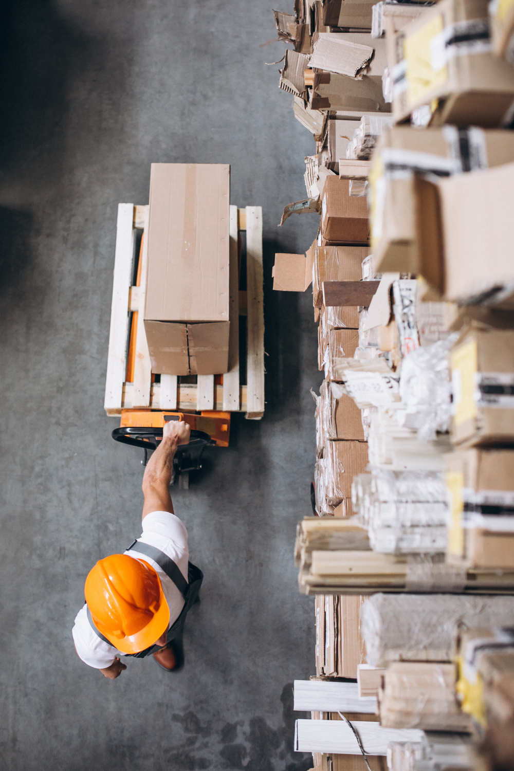 Young man working at a warehouse with boxes